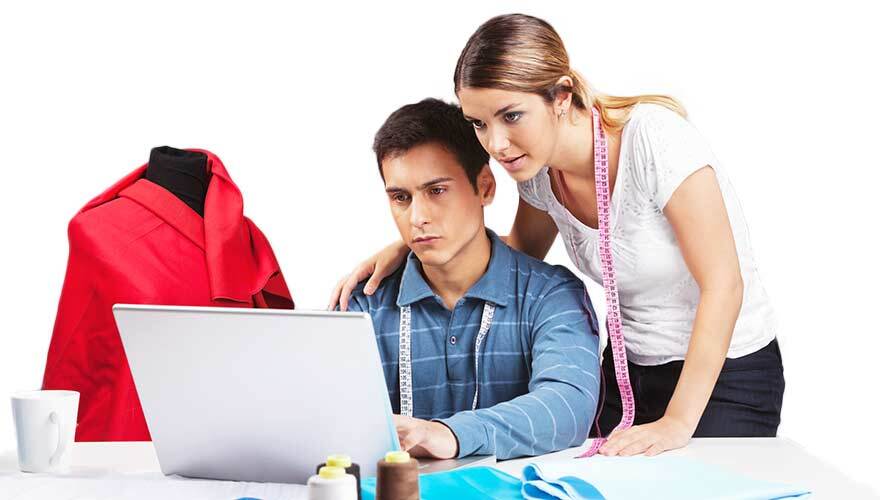 Two clothes designers looking at computer