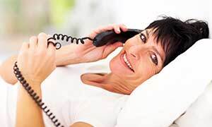 Woman talking on a landline phone