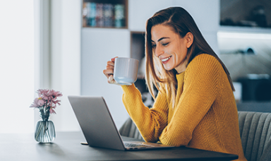 lady working on a laptop drinking coffee