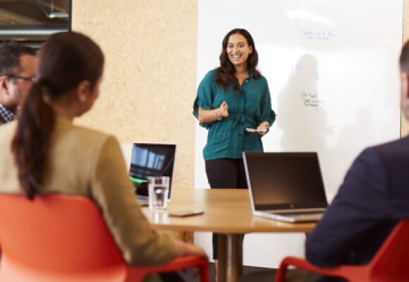 Woman in an office showing presentation to collegaues