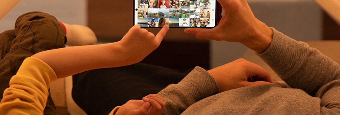 Two people looking at videos on a mobile phone