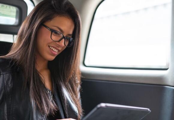 Lady looking at a tablet in a car