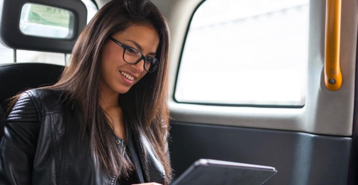 Lady looking at a tablet in a car