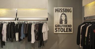 Store showing a stolen girlfriends poster and rack of clothes