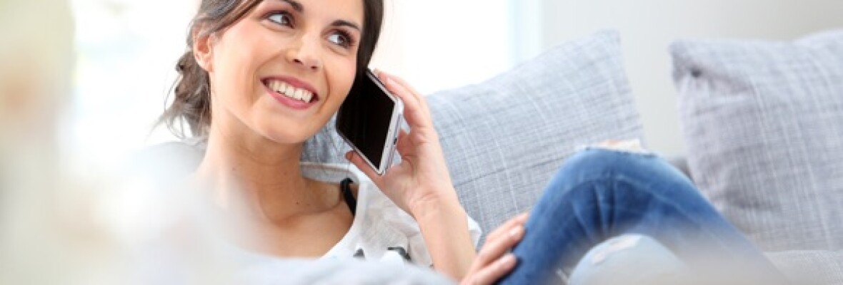 Lady on a call at home in her lounge on sofa