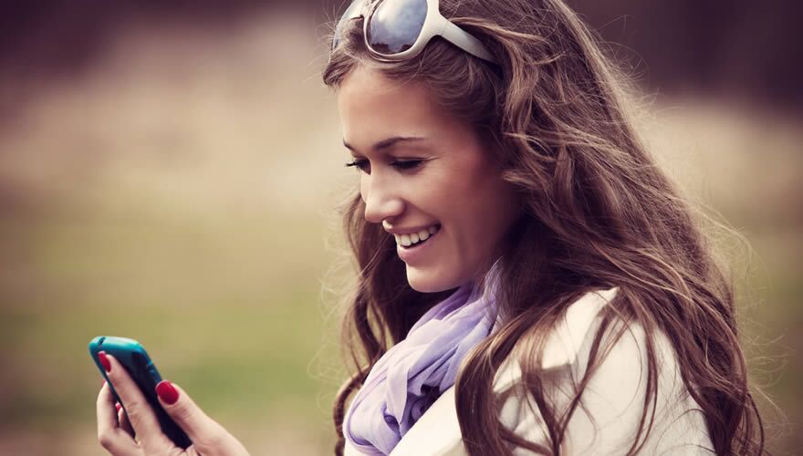 Young woman looking at her mobile phone
