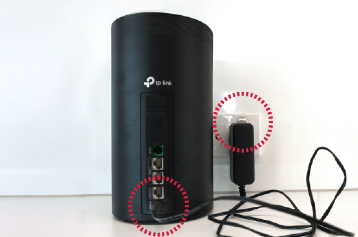TP-Link modem with highlighted power adapter and ports.