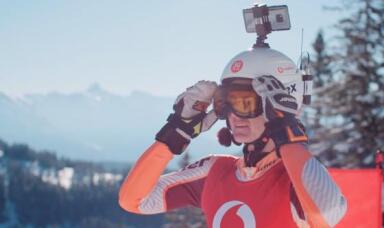 Person wearing T-Shirt with Vodafone Logo and a phone in his helmet
