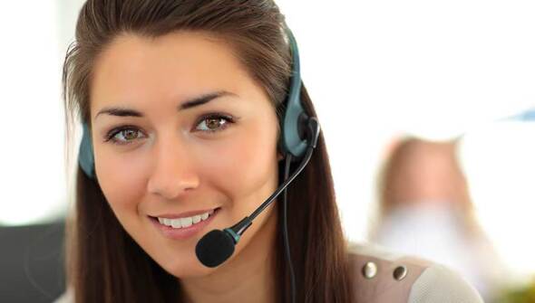 A woman working in a call centre wearing a headset
