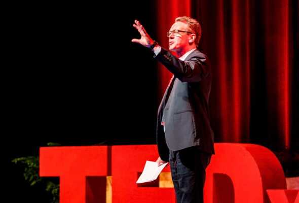 A man onstage at TedX talking