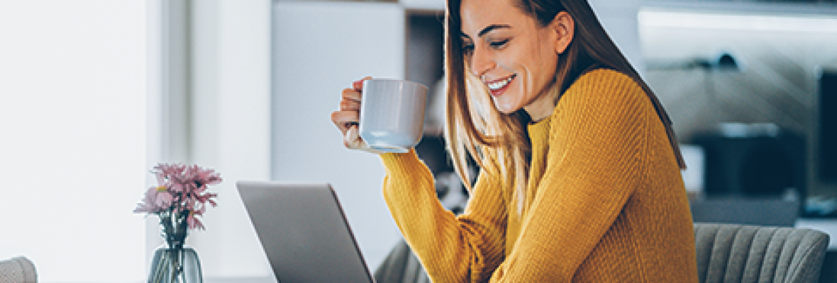 lady working on a laptop drinking coffee