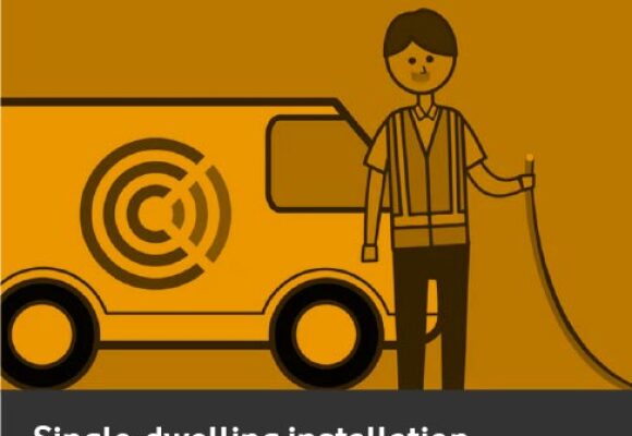 man with a wire standing in front of a van