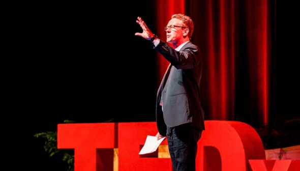 A man onstage at TedX talking