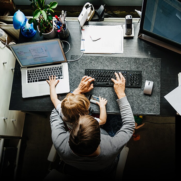 parent working from home with child on lap