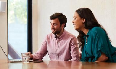 Man and woman looking at a laptop