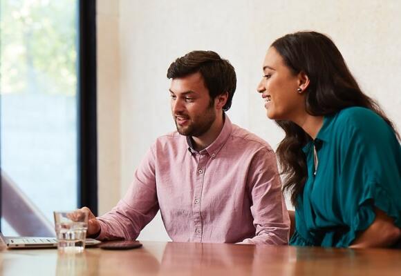 Man and woman looking at a laptop