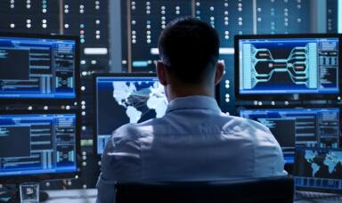 Man looking at multiple computer screens