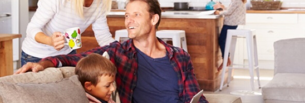 Family sitting on the couch smiling