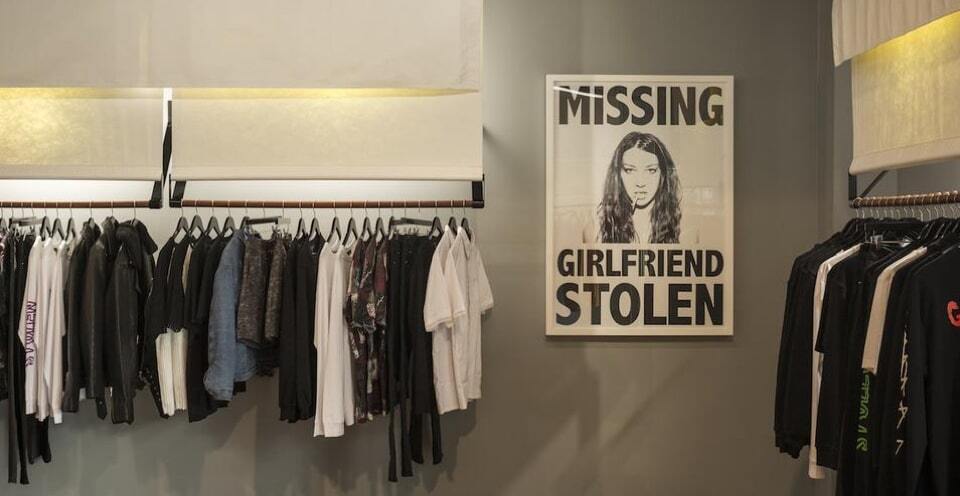 Store showing a stolen girlfriends poster and rack of clothes