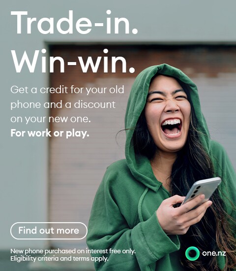 Super happy about her Trade-in value, lady in a green hoody, laughing.