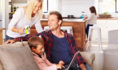 Family sitting on the couch smiling
