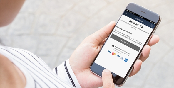 Woman looking at auto top up page on her mobile phone