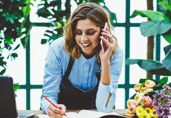 Florist taking order over the phone from customer