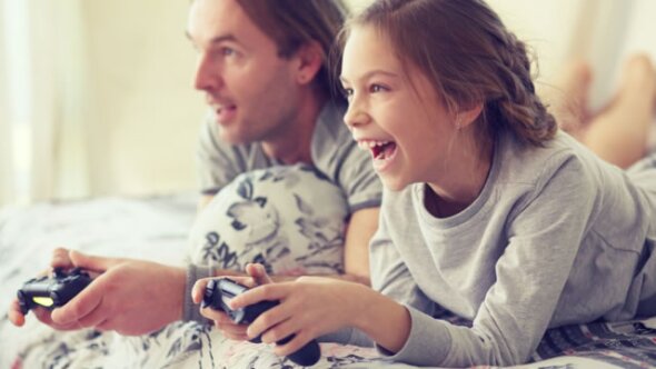 man and kid playing video game 