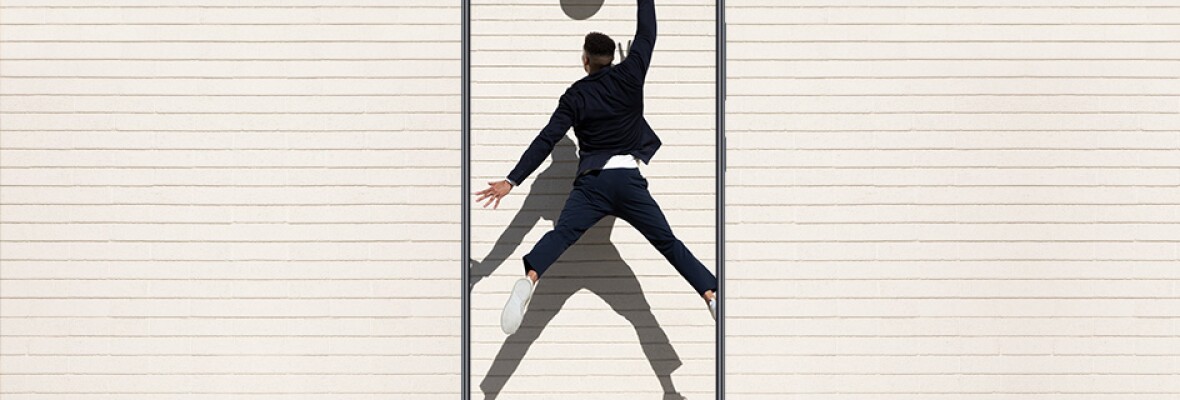 Man playing basketball shown inside a mobile phone