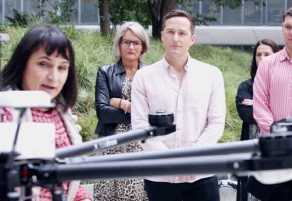 People looking at a drone