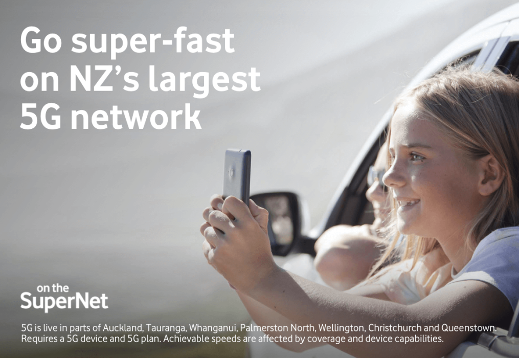 Go super-fast on NZ's largest 5G network. Girl looking at her mobile phone in a car.