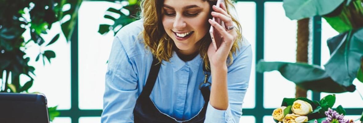 Florist taking order over the phone from customer