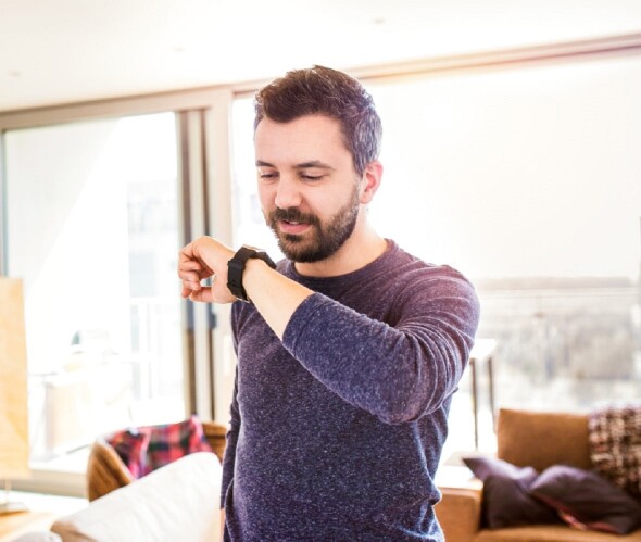 A man checks his smart watch