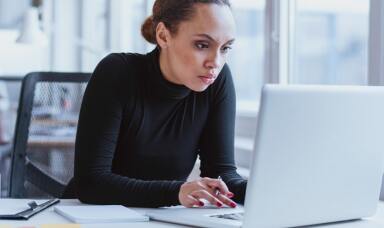 Woman looking at a laptop in an office