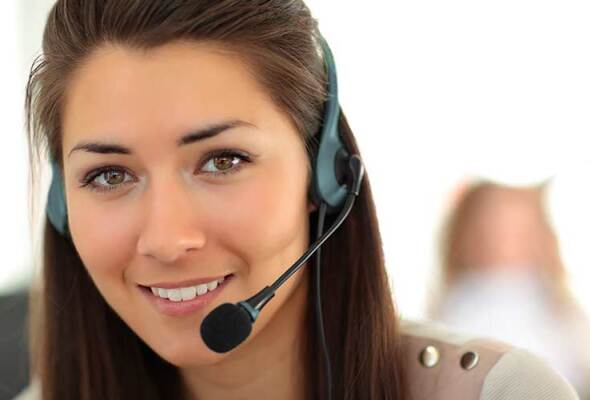 A woman working in a call centre wearing a headset