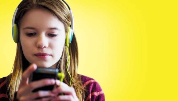 Young girl listening to music on her smartphone