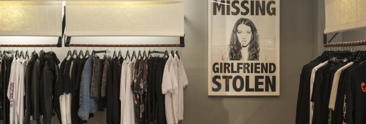 Store showing a stolen girlfriends poster and rack of clothes