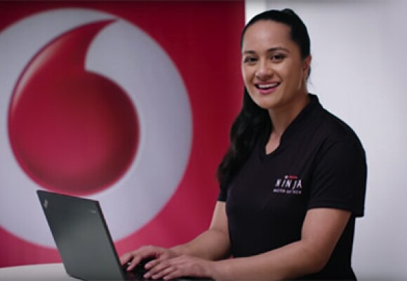 A female Vodafone Ninja types on her laptop