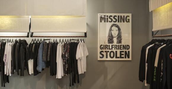 Store showing a stolen girlfriends poster and rack of clothes