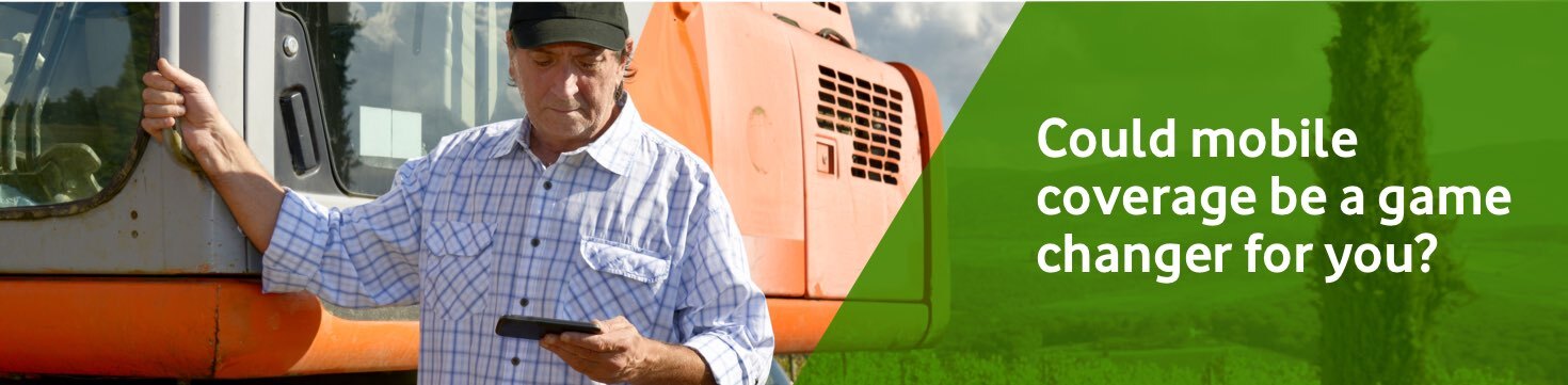 Man looking at his phone next to a truck