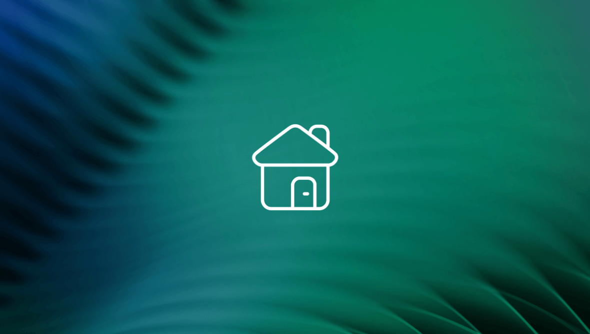 white icon of a home in front of green leaf background