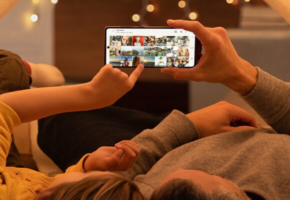 Two people looking at videos on a mobile phone