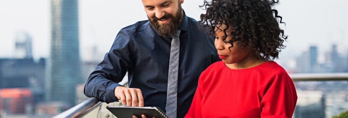 A man and a woman looking at a tablet