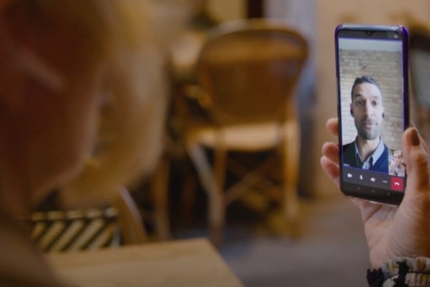 Woman talking to coworker on her phone on a Video call