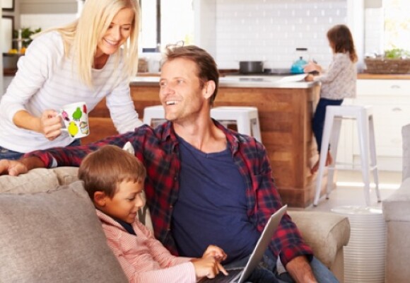 Family sitting on the couch smiling